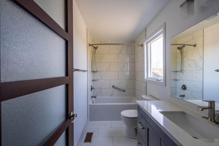 Renovated Bathroom In Ottawa South Tiled Flooring Tub And Tile Combo New Vanity 768x512
