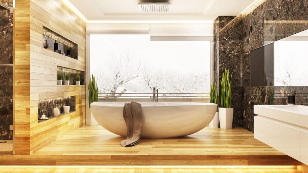 Bathtub on a wooden floor with a window and winter scenery behind