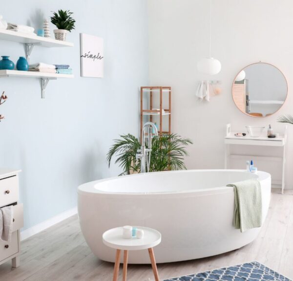 Standalone bath tub in the middle of a bathroom set in white colors