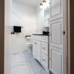 Bathroom renovation in Ottawa large scale flooring tiles white vanity