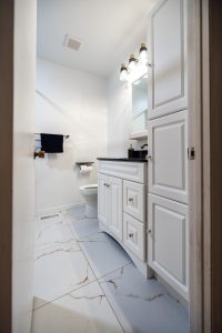 powder room renovation in Stittsville large scale flooring tiles white vanity