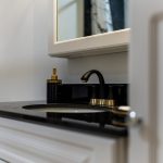 Bathroom renovation in Ottawa lwhite vanity with black top and black faucet