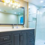 Full Bathroom renovation Grey vanity Subway tiles free standing tub tiled floor Schluter Systems