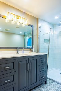 Full Bathroom renovation Grey vanity Subway tiles free standing tub tiled floor Schluter Systems
